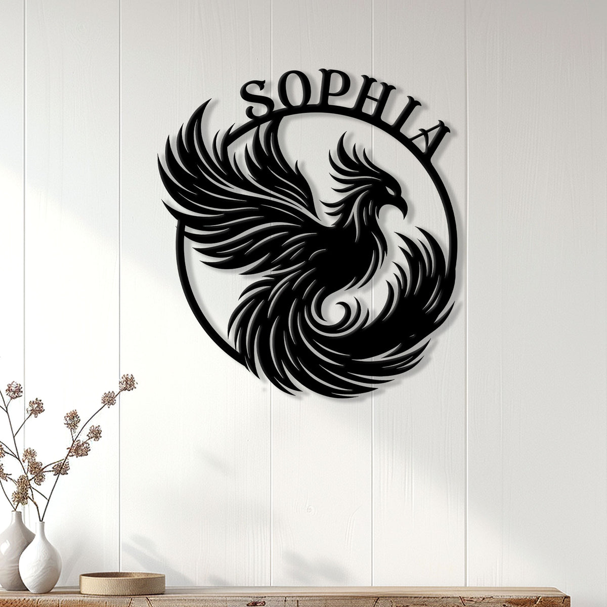 Black phoenix wall sign displayed on a white paneled wall as striking home decor