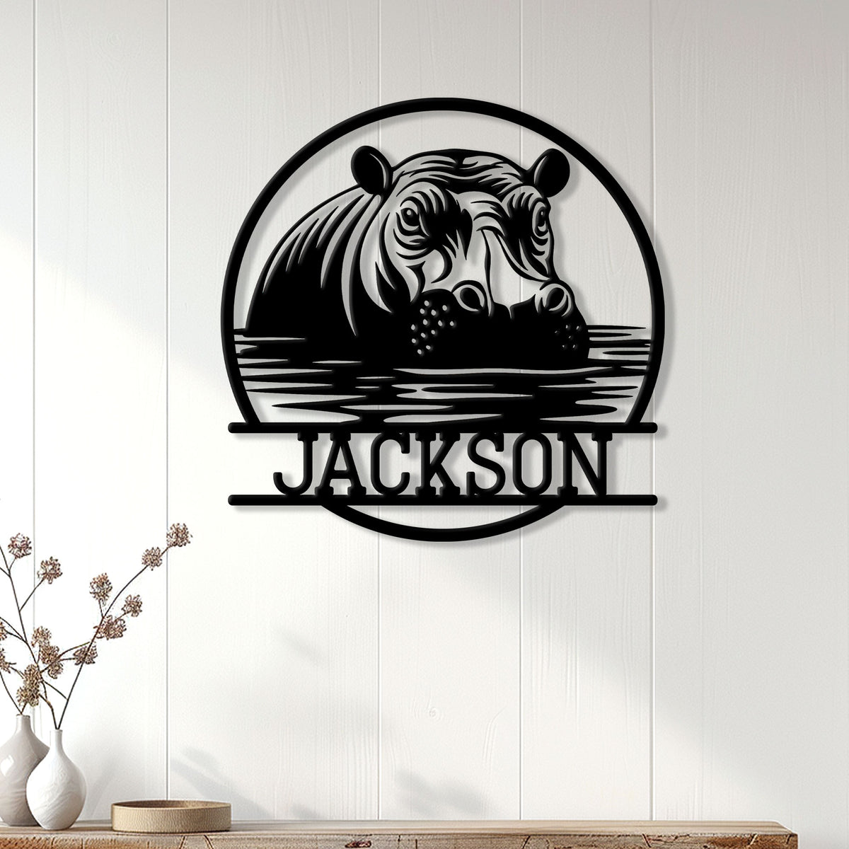 Hippo metal wall decor displayed on a light paneled wall above a console table