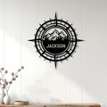 Hiking compass wall sign displayed on a light wood-paneled wall in a modern home