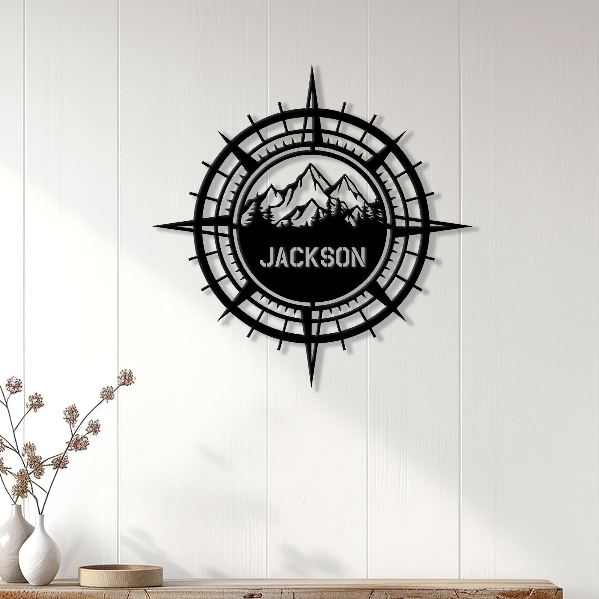 Hiking compass wall sign displayed on a light wood-paneled wall in a modern home