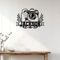 Photographer metal wall sign displayed above a rustic console table in a bright modern home
