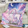 Colorful unicorn blanket draped over a sofa with pastel clouds, stars, crescent moon, and fantasy artwork