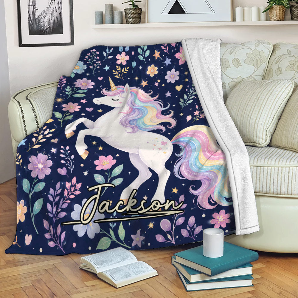Pastel unicorn throw blanket draped over a sofa with colorful flowers, stars, and fantasy artwork