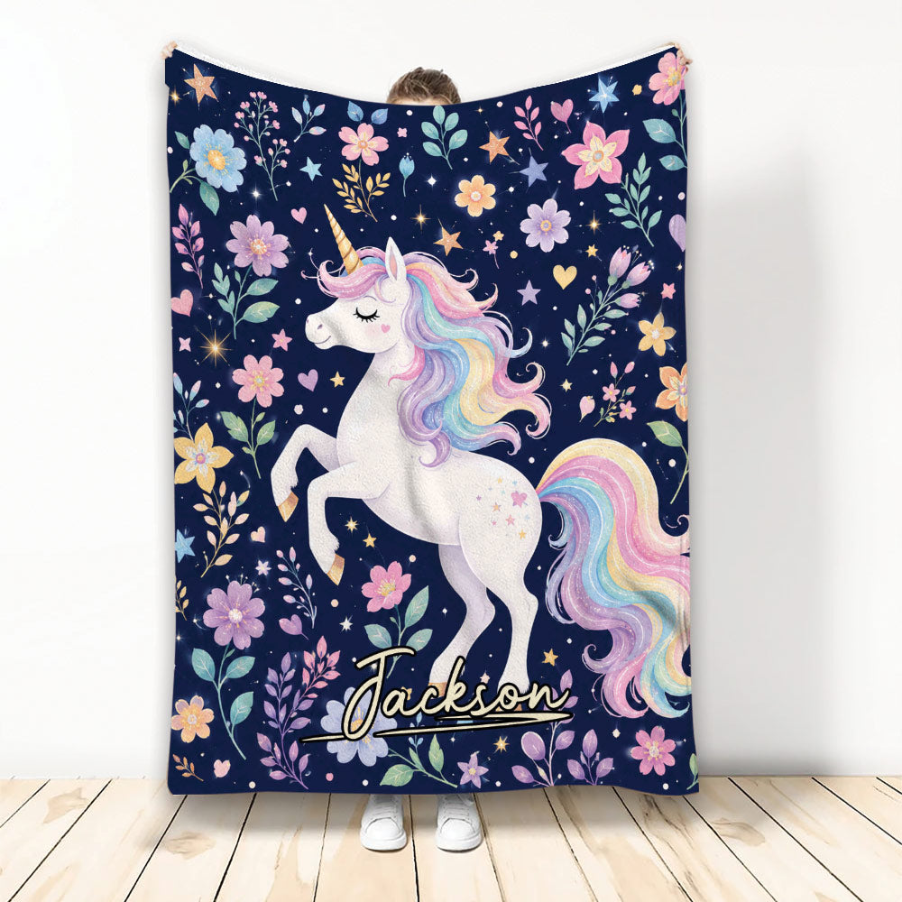 Unicorn throw blanket with pastel rainbow mane, floral details, stars, hearts, and a deep navy background