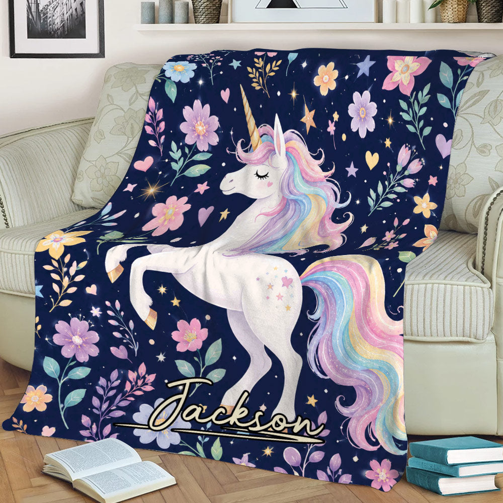 Unicorn blanket displayed on a couch with rainbow mane, floral accents, hearts, and celestial details