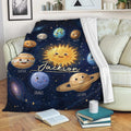 Astronaut throw blanket displayed on a sofa with colorful planets and deep space artwork