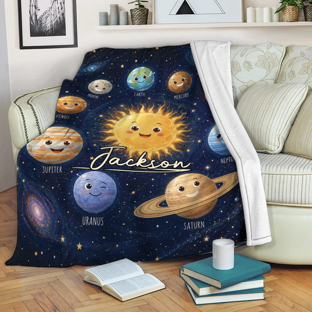 Astronaut throw blanket displayed on a sofa with colorful planets and deep space artwork