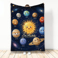 Astronaut-themed throw blanket with smiling planets, sun, stars, and galaxy artwork