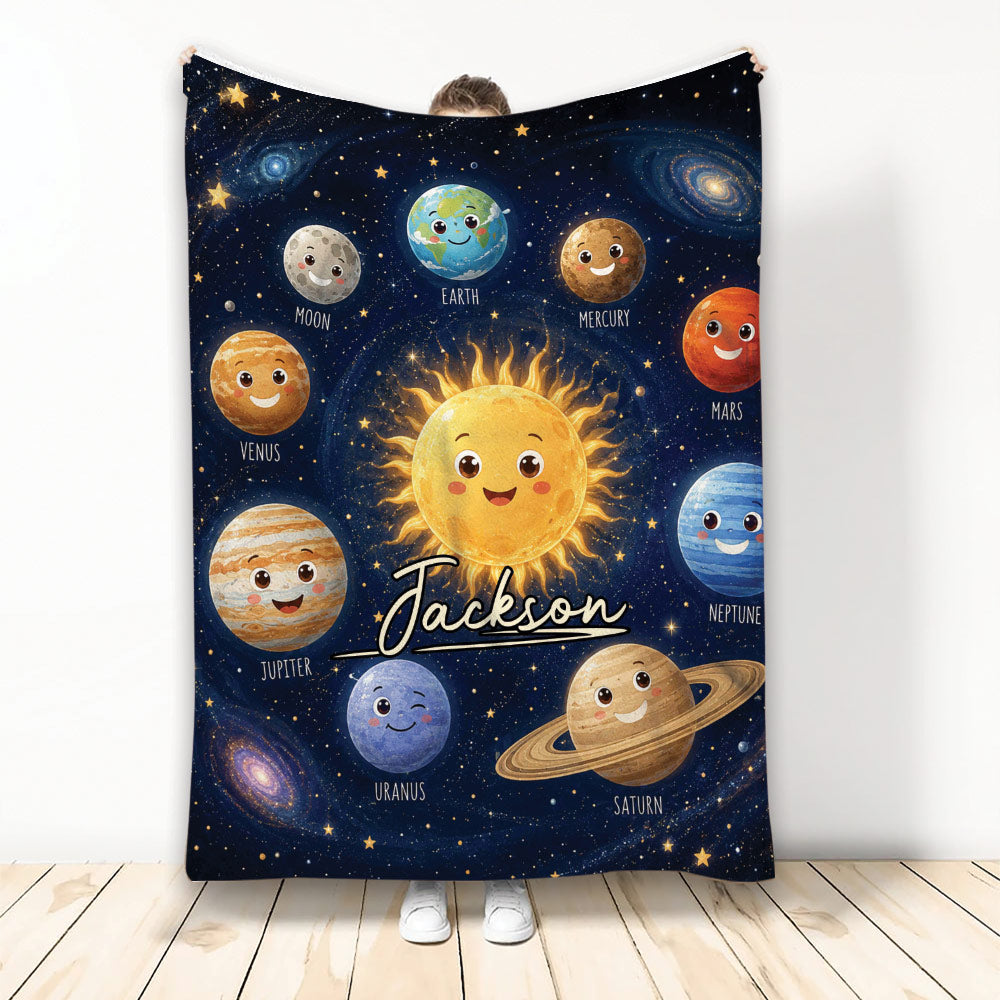 Astronaut-themed throw blanket with smiling planets, sun, stars, and galaxy artwork