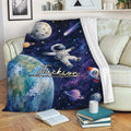 Astronaut blanket draped over a sofa with planets, stars, and space explorer artwork