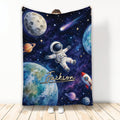 Astronaut throw blanket with colorful planets, stars, rocket, and outer-space artwork