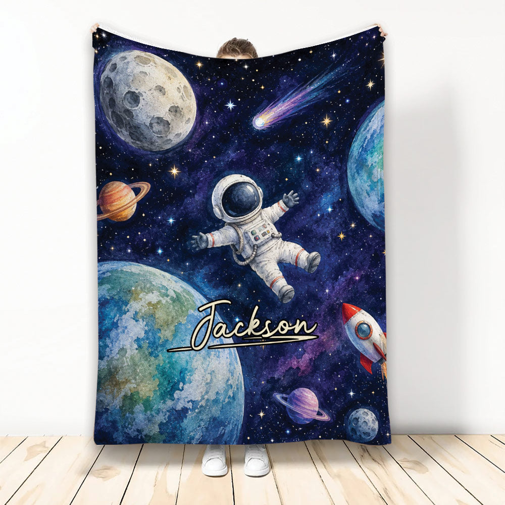 Astronaut throw blanket with colorful planets, stars, rocket, and outer-space artwork