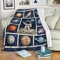Astronaut space throw blanket draped over a sofa with planets, rocket, and galaxy artwork