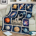 Astronaut throw blanket displayed on a sofa with colorful planets and deep space artwork