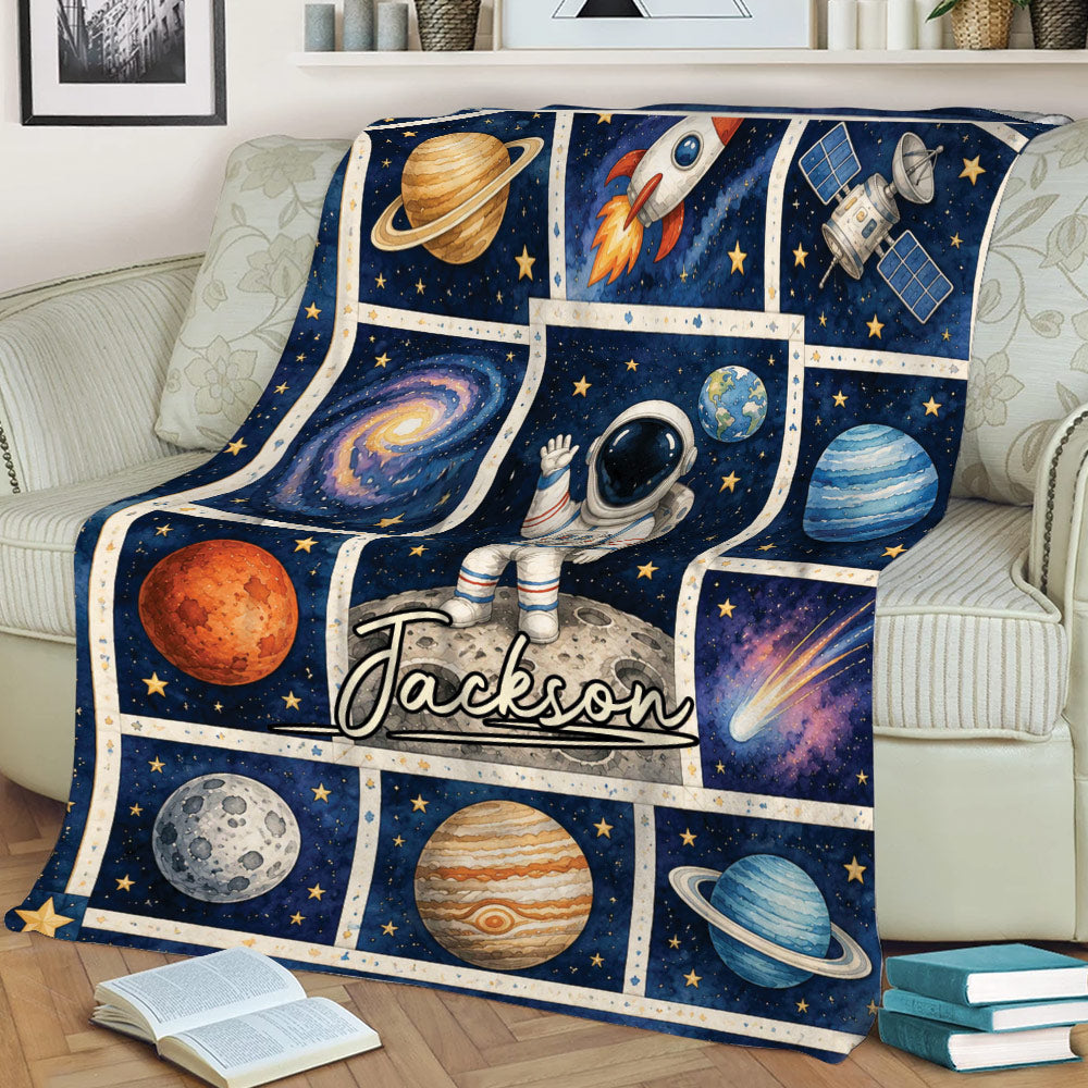 Astronaut throw blanket displayed on a sofa with colorful planets and deep space artwork