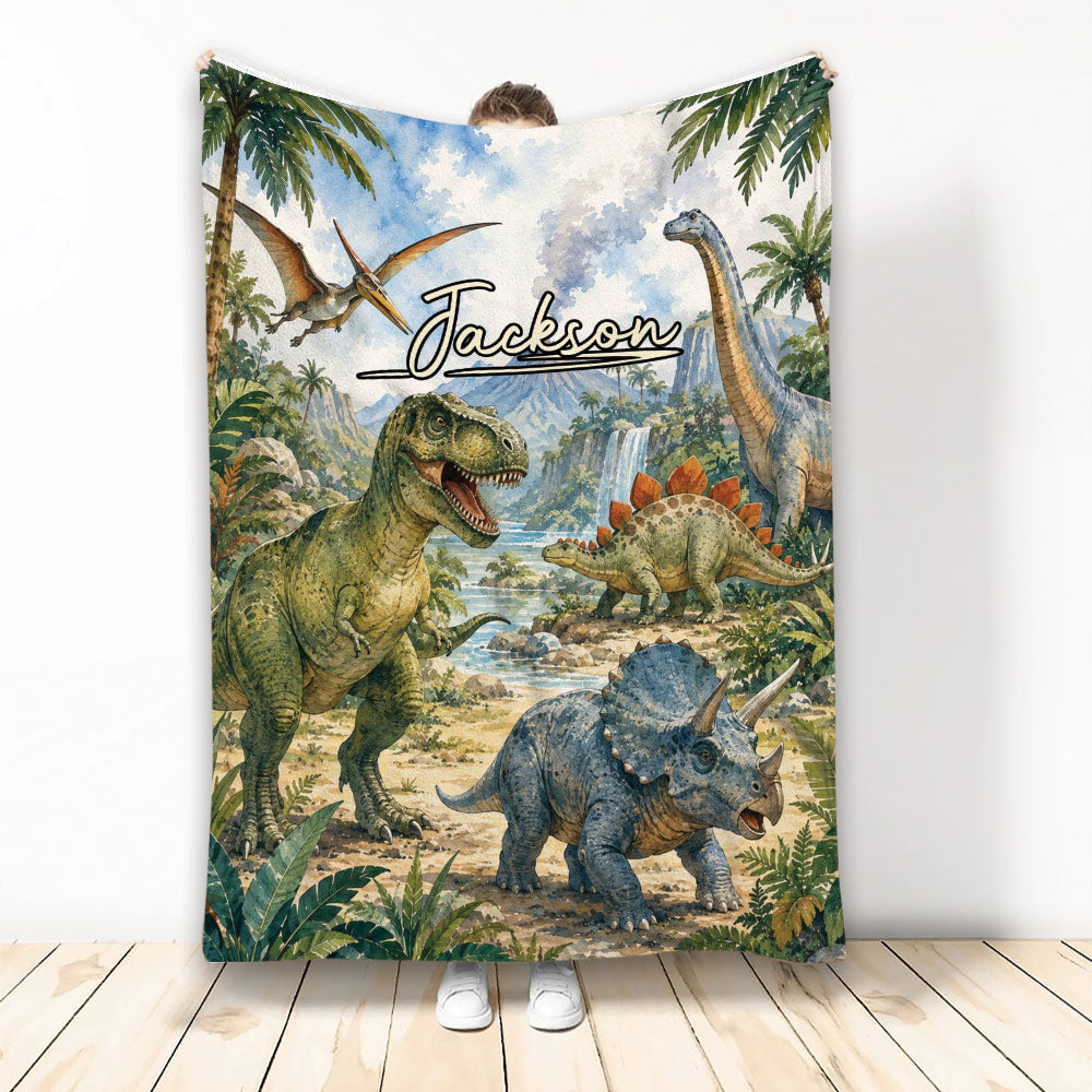 Dinosaur throw blanket featuring a T-rex, triceratops, stegosaurus, pterosaur, and lush prehistoric jungle scenery
