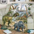Dinosaur throw blanket displayed on a couch with T-rex, triceratops, stegosaurus, and waterfall artwork
