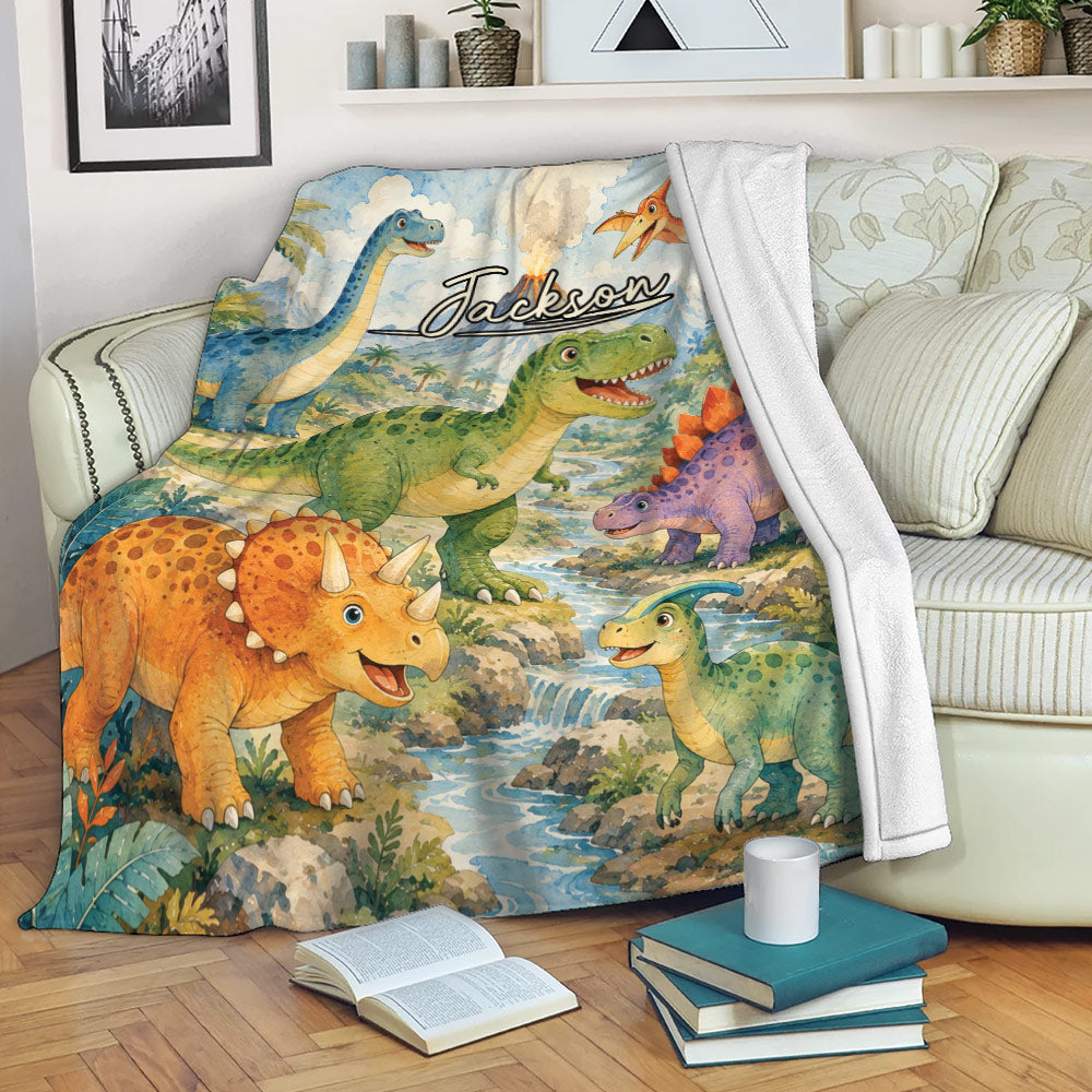 Dinosaur throw blanket draped over a sofa with colorful prehistoric creatures, jungle scenery and a river landscape