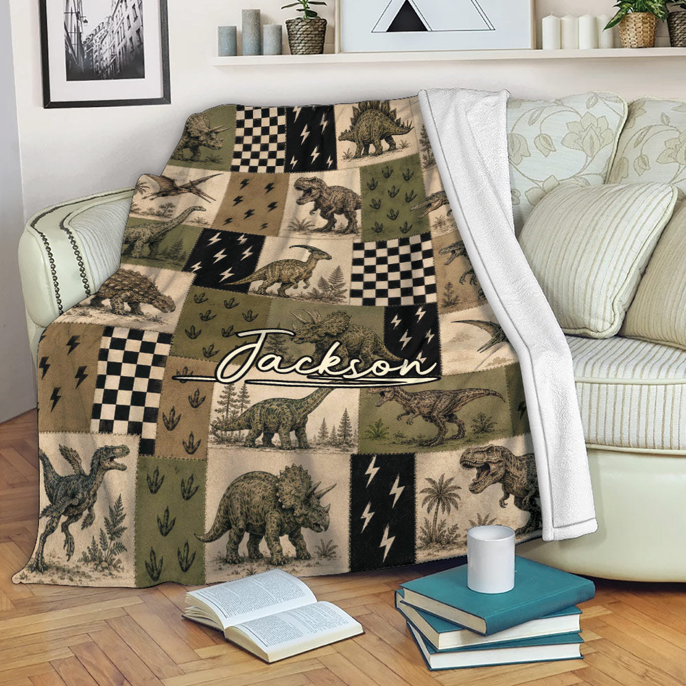 Dinosaur throw blanket draped over a sofa, featuring vintage dinosaur illustrations and earthy patchwork panels