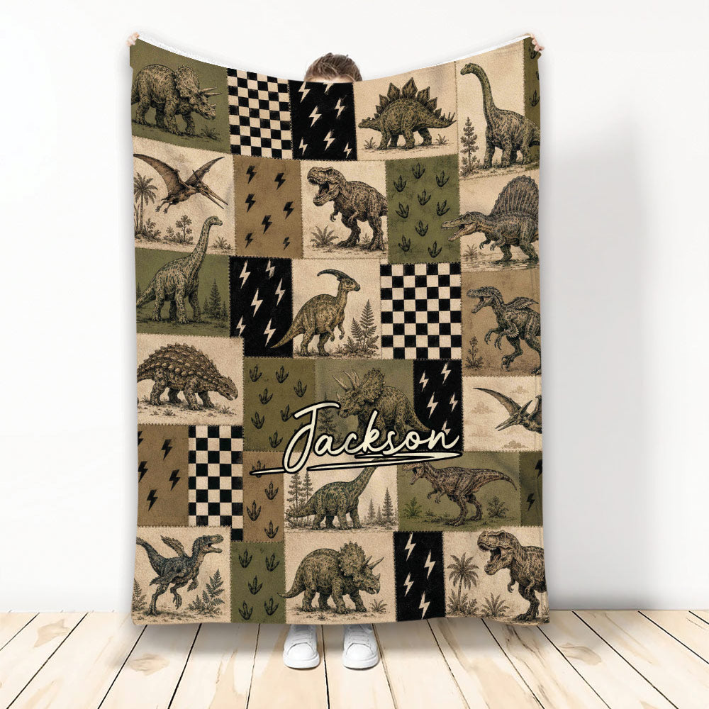 Vintage dinosaur patchwork throw blanket displayed upright with illustrated dinosaurs and checkerboard accents