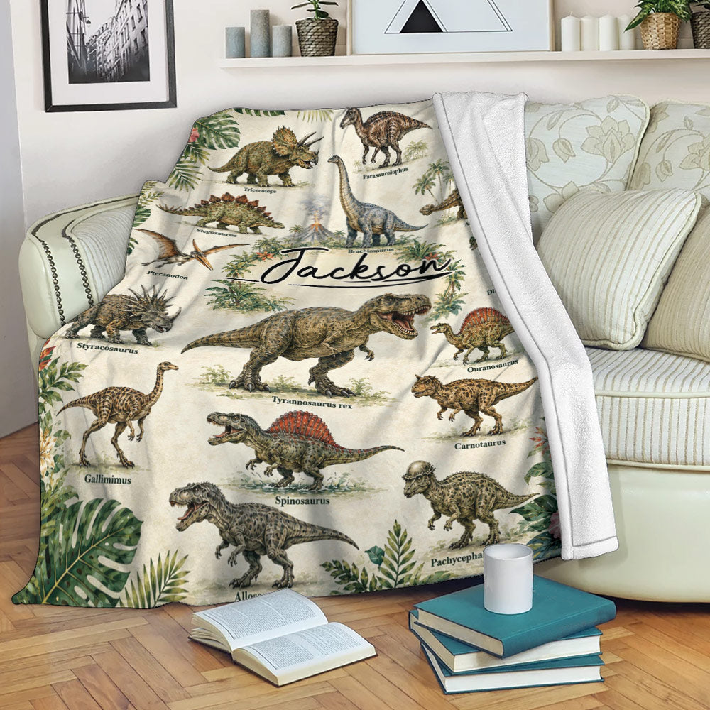 Dinosaur blanket displayed on a sofa with illustrated prehistoric creatures and jungle foliage
