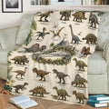 Dinosaur throw blanket draped across a sofa, featuring illustrated prehistoric creatures, tropical plants, and volcano artwork