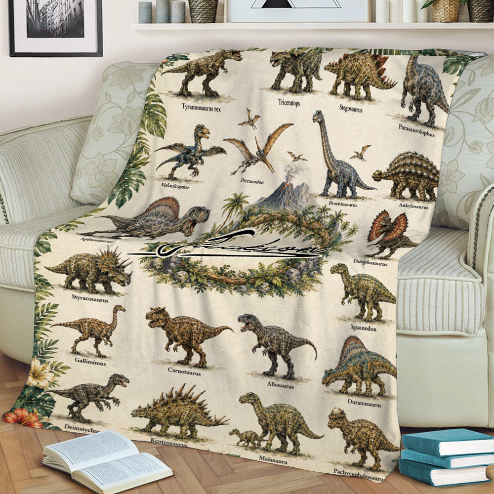 Dinosaur throw blanket draped across a sofa, featuring illustrated prehistoric creatures, tropical plants, and volcano artwork