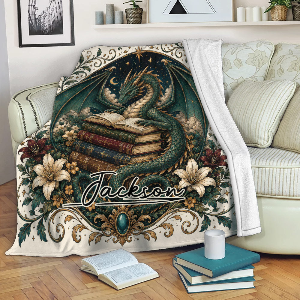 Dragon throw blanket draped over a sofa with fantasy book artwork, flowers, stars, and decorative borders