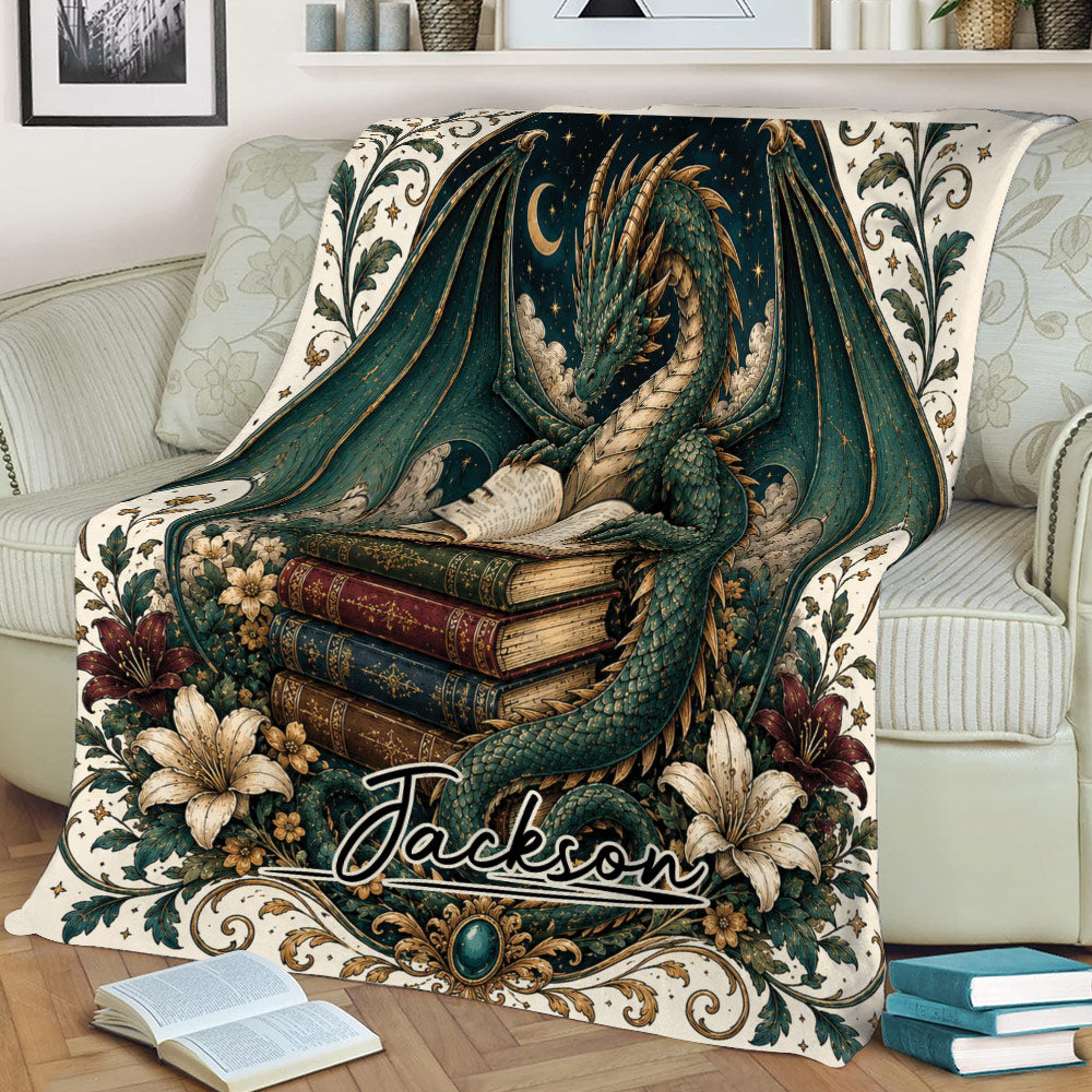 Fantasy dragon blanket displayed on a sofa with an open book, stacked books, florals, and celestial artwork