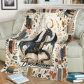Fantasy dragon blanket displayed on a couch with open books, botanical accents, and vintage book artwork