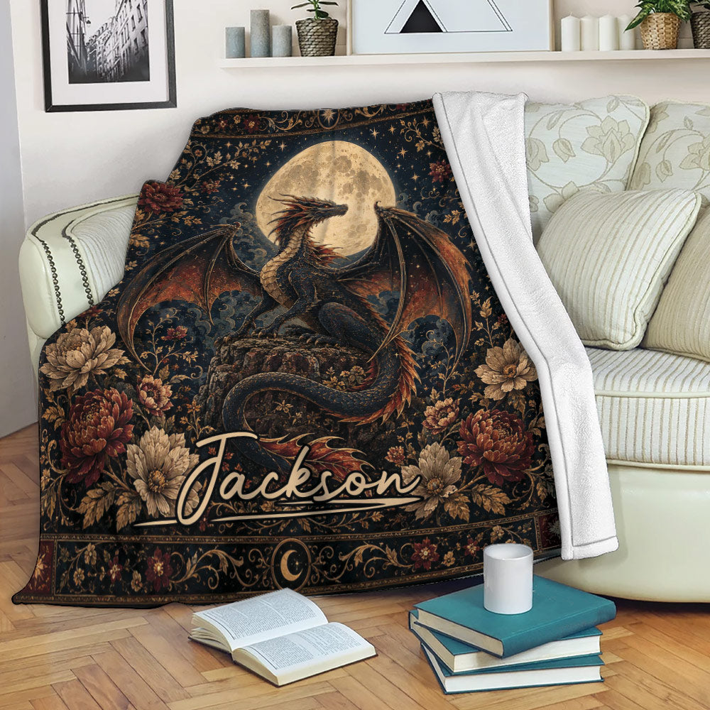 Dragon blanket draped over a sofa with moonlit fantasy artwork and ornate floral details