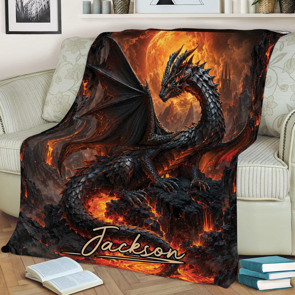 Fantasy dragon blanket spread across a couch with wings, lava landscape, and glowing volcanic scenery