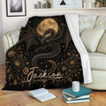 Black and gold dragon throw blanket displayed on a sofa with floral and celestial artwork