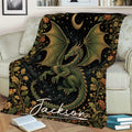 Fantasy dragon blanket draped across a sofa with moonlit floral artwork