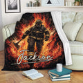 Firefighter throw blanket displayed on a sofa with bold flame artwork in black, red, orange, and yellow