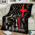 Firefighter throw blanket draped across a sofa, featuring a helmeted firefighter, axe, smoke, stars, and red cross