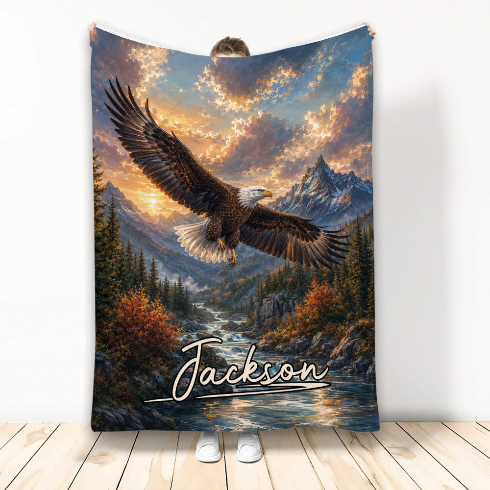 Bald eagle flying over a mountain valley and river in a dramatic sunset landscape blanket design