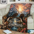 Eagle throw blanket displayed on a sofa with two perched eagles, mountains, a river, and floral scenery