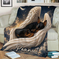 Close lifestyle view of a sleeping black-and-tan Miniature Pinscher surrounded by feathered wings on a couch blanket