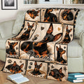 Close view of a Miniature Pinscher throw blanket displayed on a sofa with cozy dog collage artwork