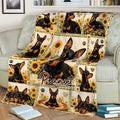 Sunflower Miniature Pinscher throw blanket draped over a sofa with repeated dog artwork