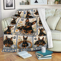 Miniature Pinscher blanket draped over a sofa, featuring black-and-tan dogs, floral artwork, and paw prints