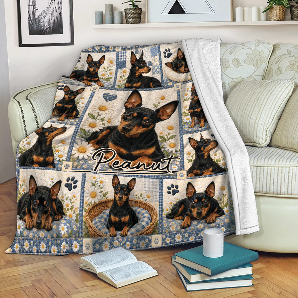 Miniature Pinscher blanket draped over a sofa, featuring black-and-tan dogs, floral artwork, and paw prints