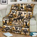 Miniature Schnauzer blanket displayed on a couch with sunflower panels and black and cream dog artwork