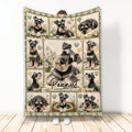 Miniature Schnauzer blanket with multiple dog portraits, daisies, hearts, paw prints, and rustic green accents