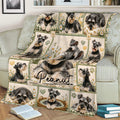 Miniature Schnauzer blanket draped over a couch, featuring repeated dog portraits, daisies, hearts, and paw prints