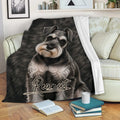 Miniature Schnauzer throw blanket draped over a living room sofa with books nearby