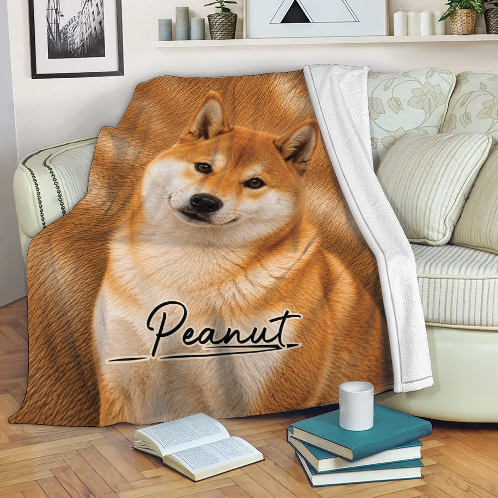 Shiba Inu throw blanket draped across a sofa in a cozy living room setting