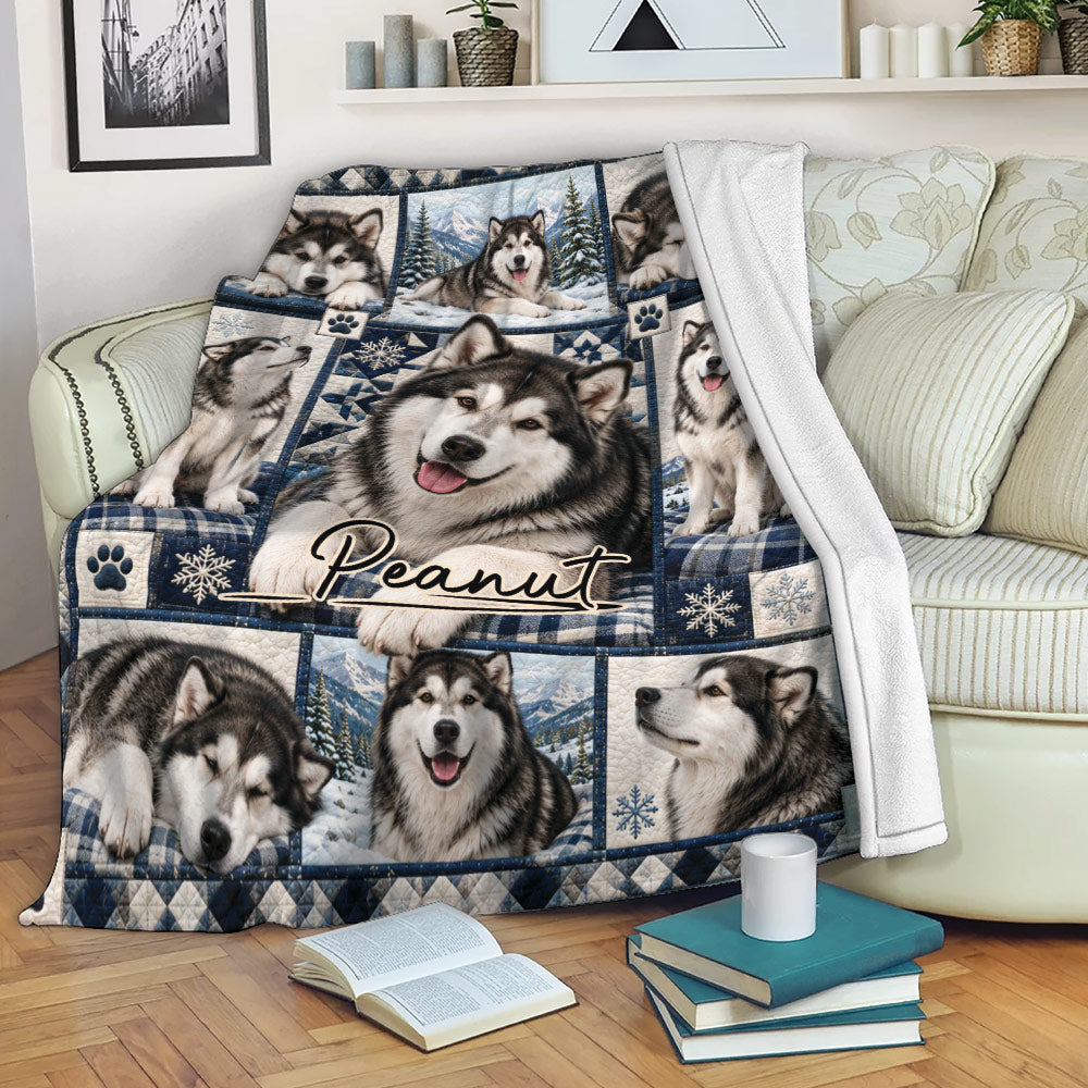 Alaskan Malamute throw blanket displayed on a sofa with snowy dog artwork and cozy living room styling