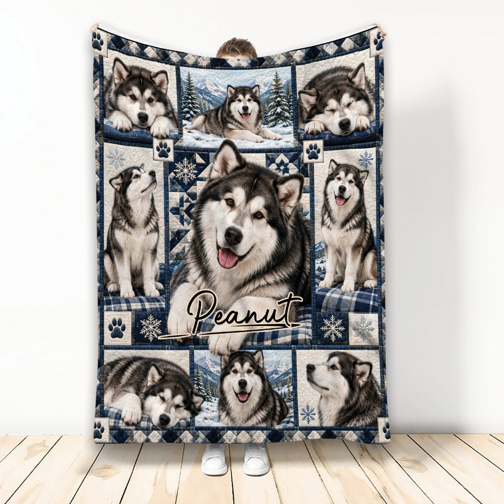 Alaskan Malamute blanket featuring multiple dogs, snowy mountains, paw prints, and blue winter artwork